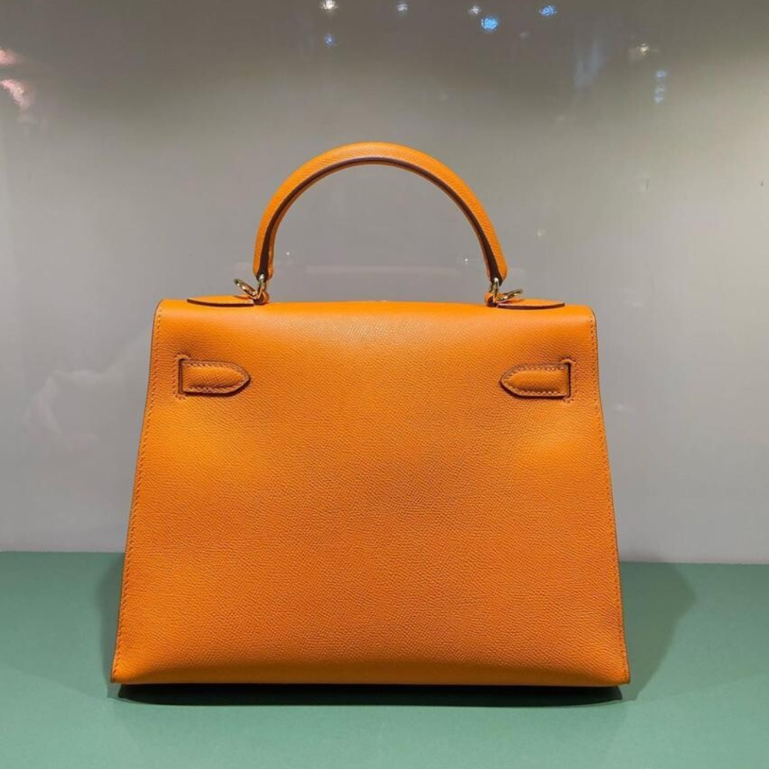 Hermès – Kelly 25-tas in oranje met goudkleurige hardware